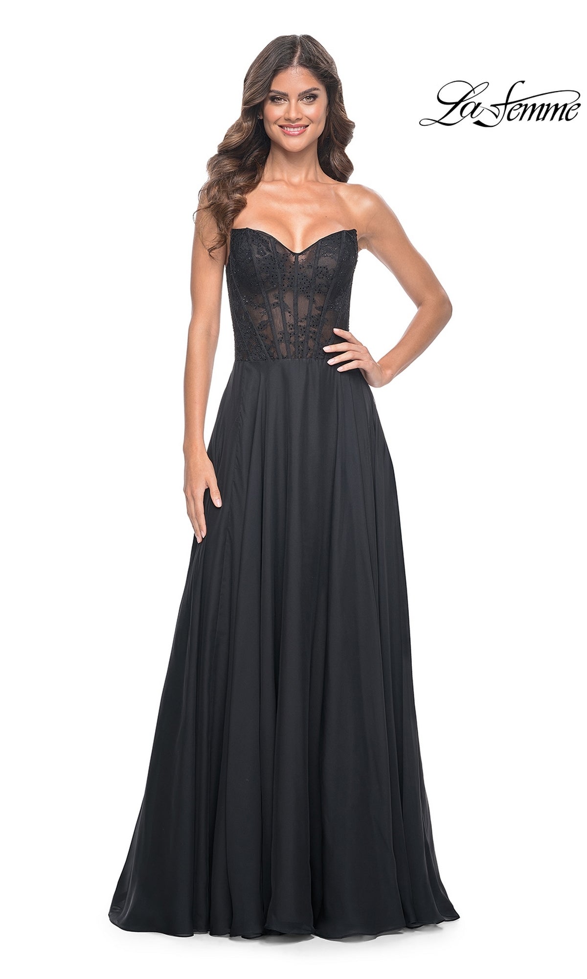 A woman models the La Femme Lace-Bodice Long A-Line Prom Dress 32311, featuring a strapless sheer lace bodice and flowing skirt, against a white background.